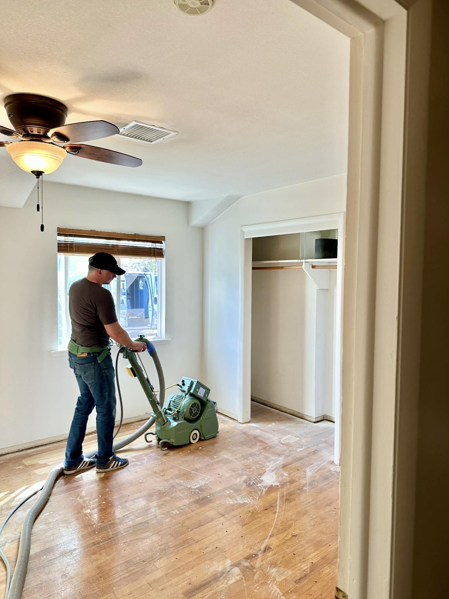 Dustless process sanding machine on hardwood floor